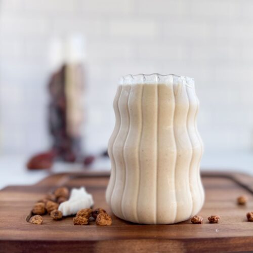 A cup of Tigernut Milk with dates and coconuts.